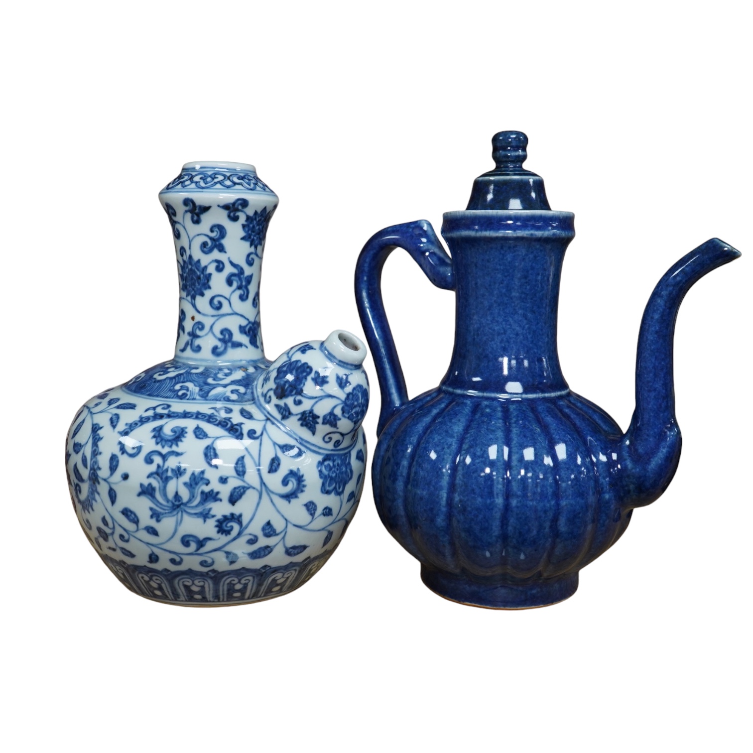 A Chinese porcelain powder blue ewer with cover and a similar blue and white example, largest 25cm high. Condition - good